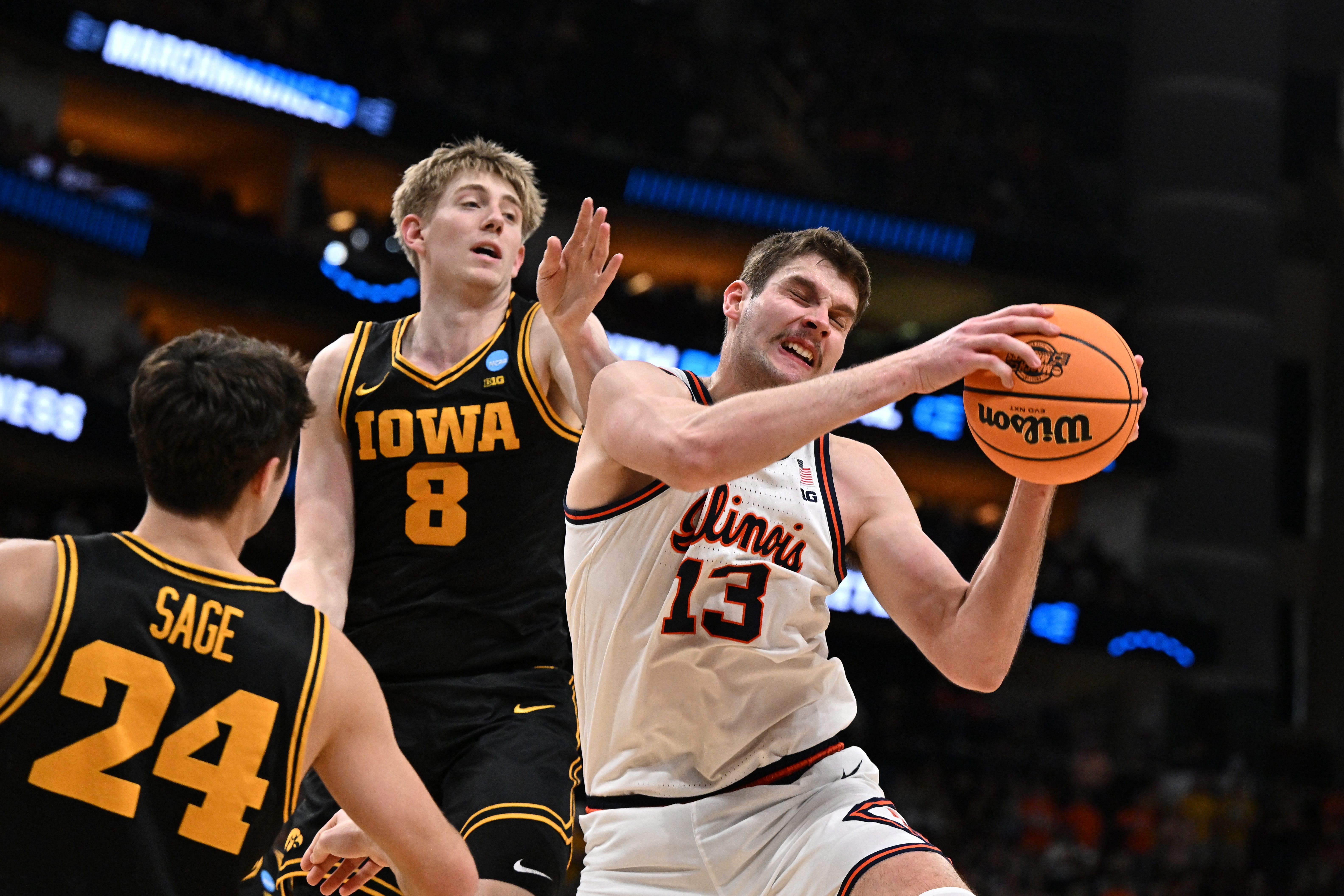 Mar 28, 2026; Houston, TX, USA; Illinois Fighting Illini center Tomislav Ivisic (13) grabs a rebound against Iowa Hawkeyes forward Cooper Koch (8) in the second half during an Elite Eight game of the South Regional of the men's 2026 NCAA Tournament at Toyota Center. Mandatory Credit: Maria Lysaker-Imagn Images