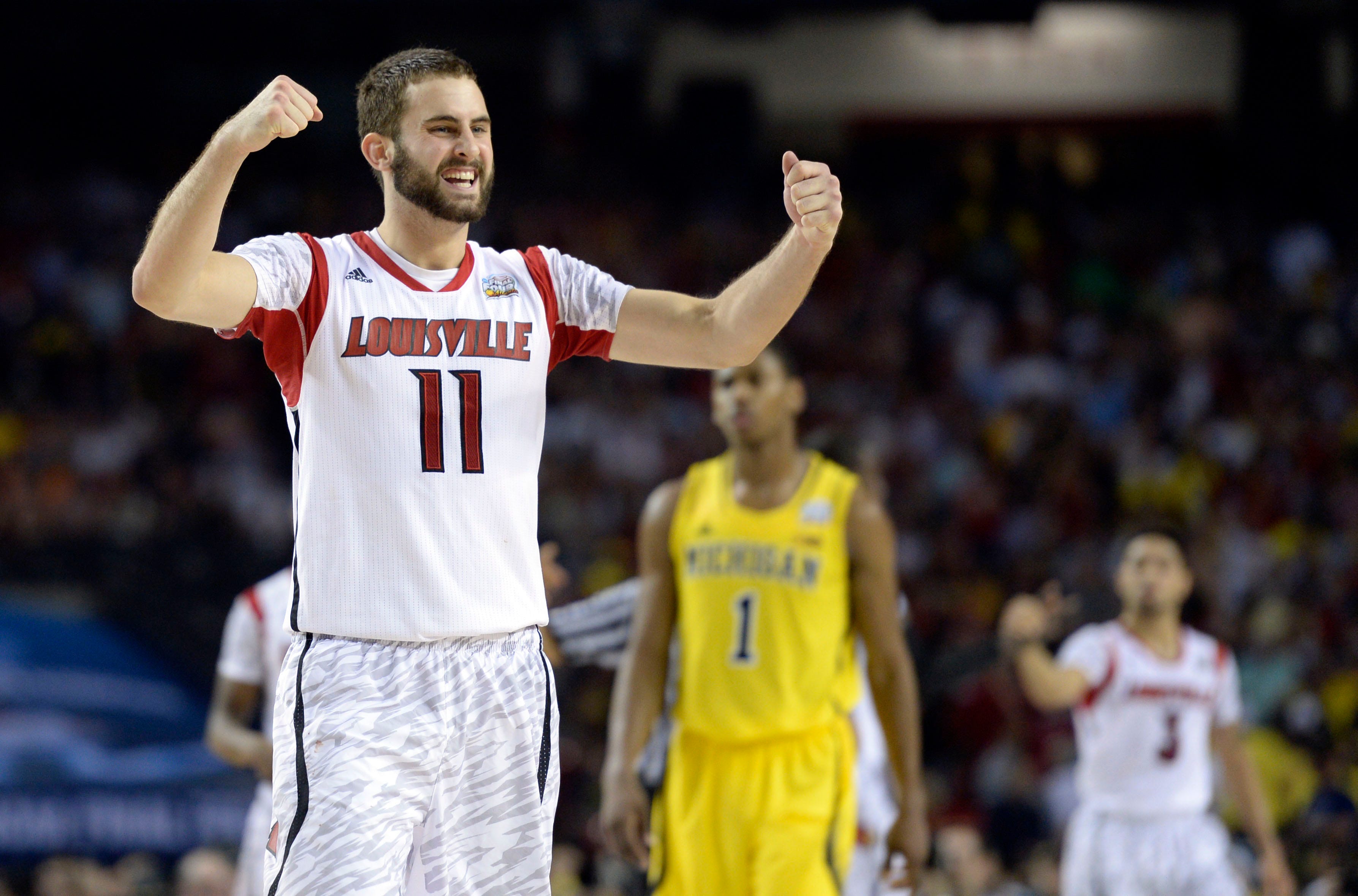 Louisville Cardinals guard/forward Luke Hancock celebrates.