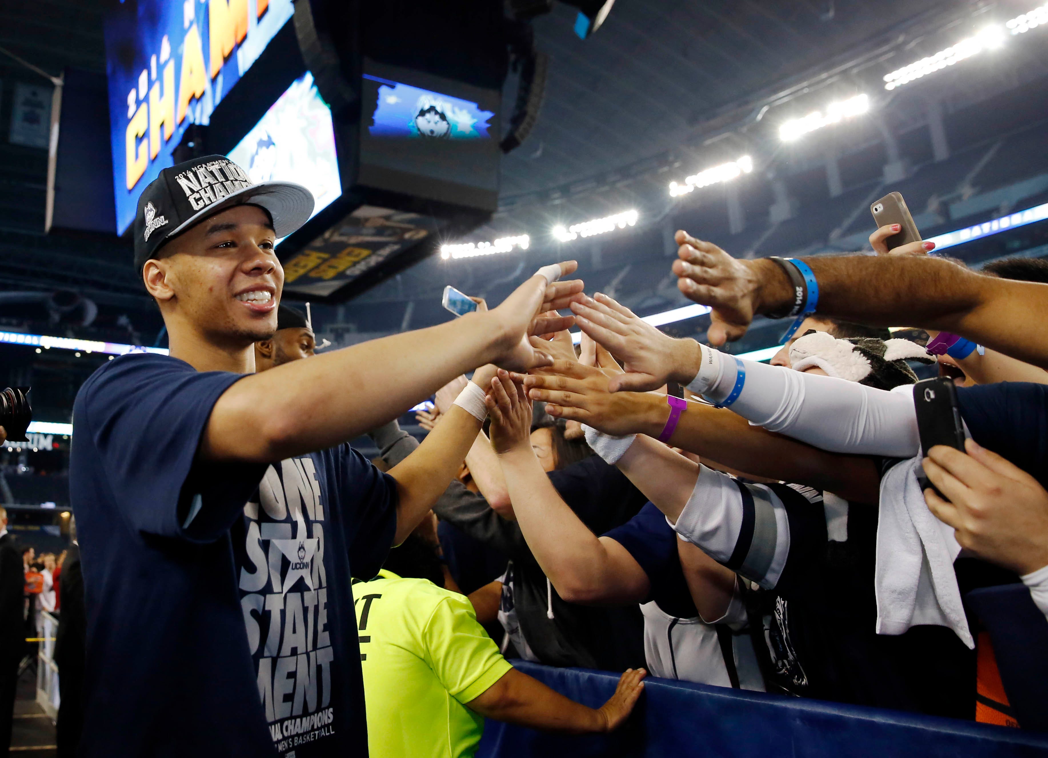 Connecticut Huskies guard Shabazz Napier (13) celebrates with fans after beating the Kentucky Wildcats.