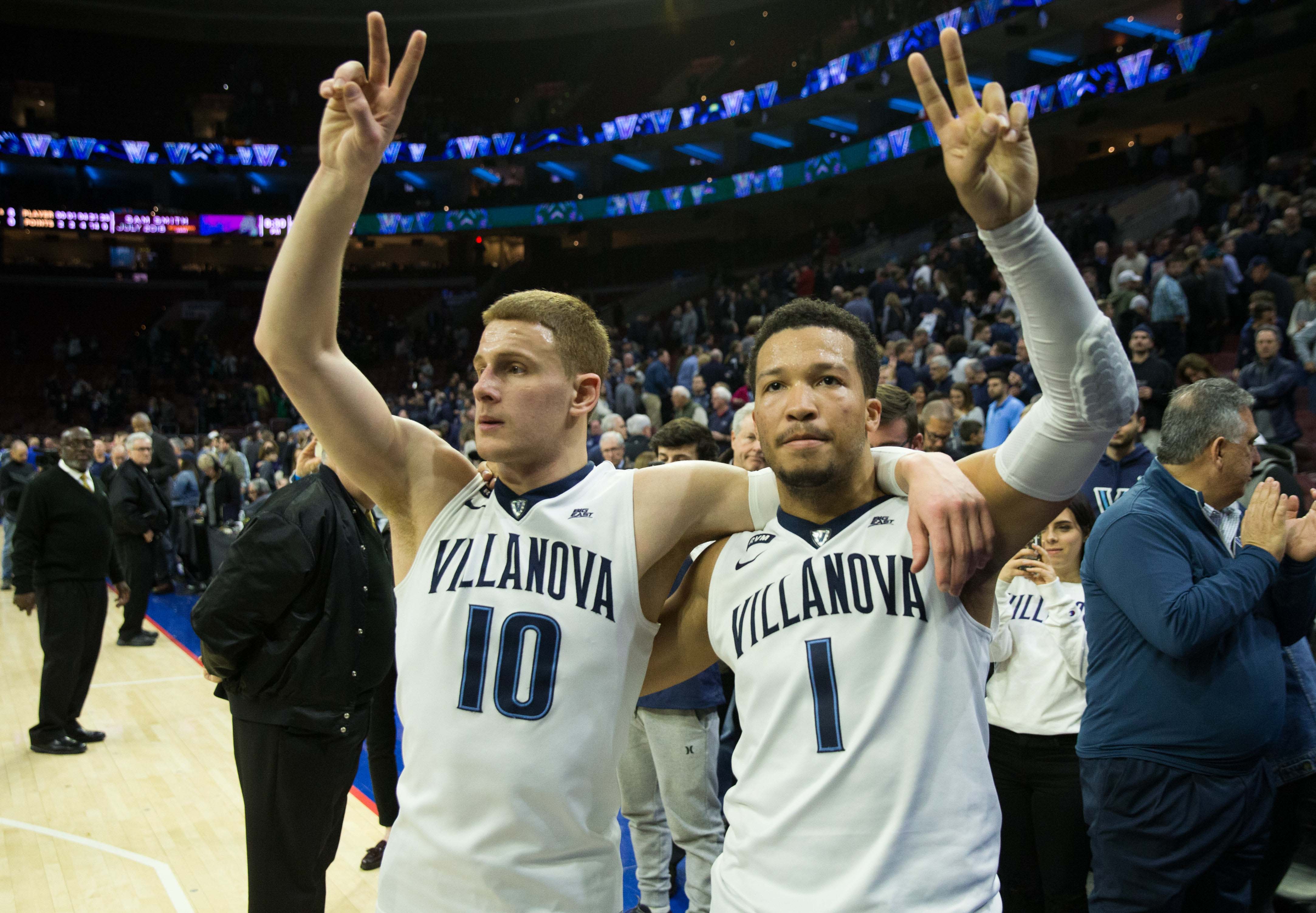 Villanova Wildcats guard Donte DiVincenzo (10) and guard Jalen Brunson (1) salute the student section.