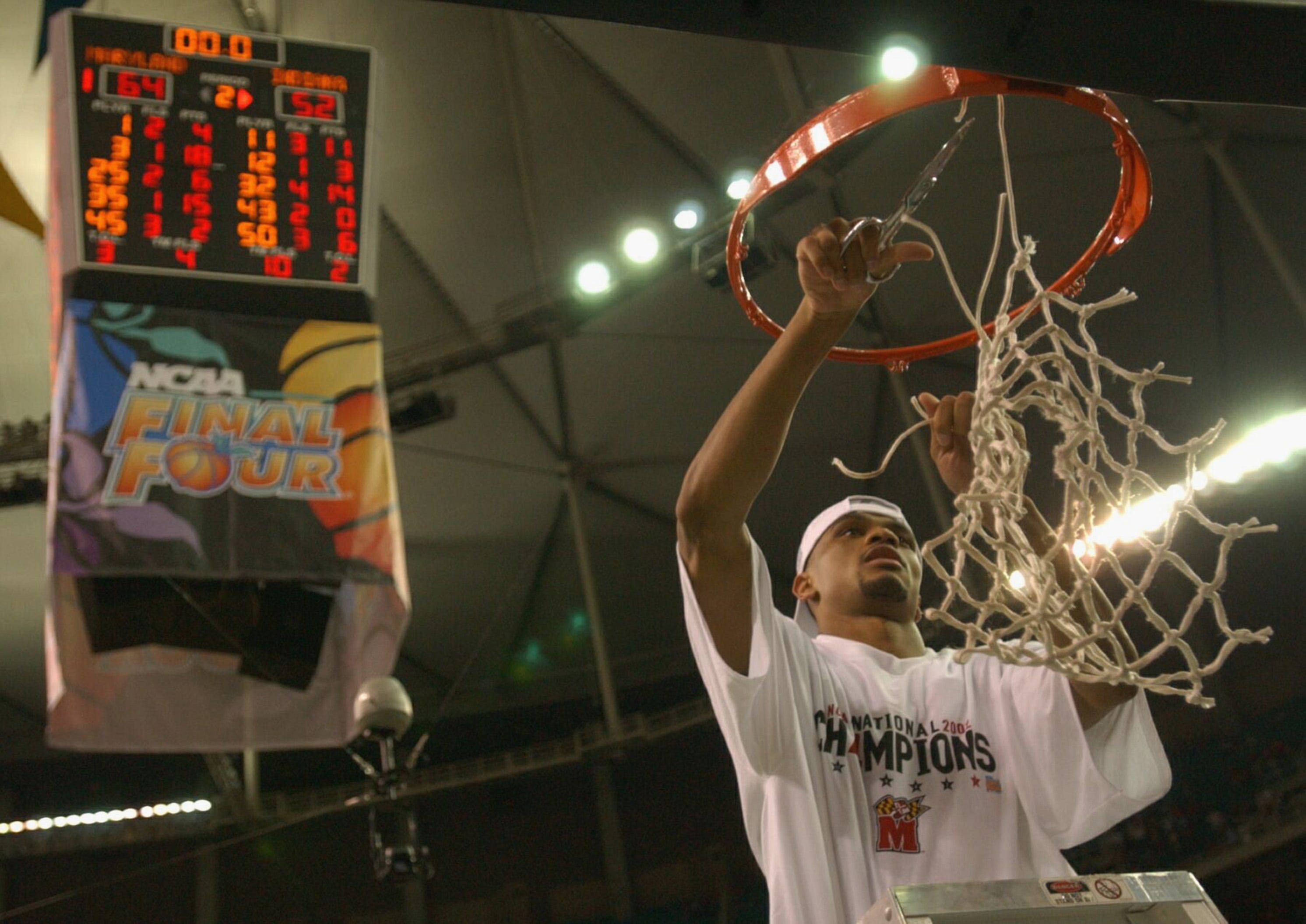 Juan Dixon of the University of Maryland Terrapins celebrates by cutting down the net after the men's NCAA National Championship game against the Indiana University Hoosiers.