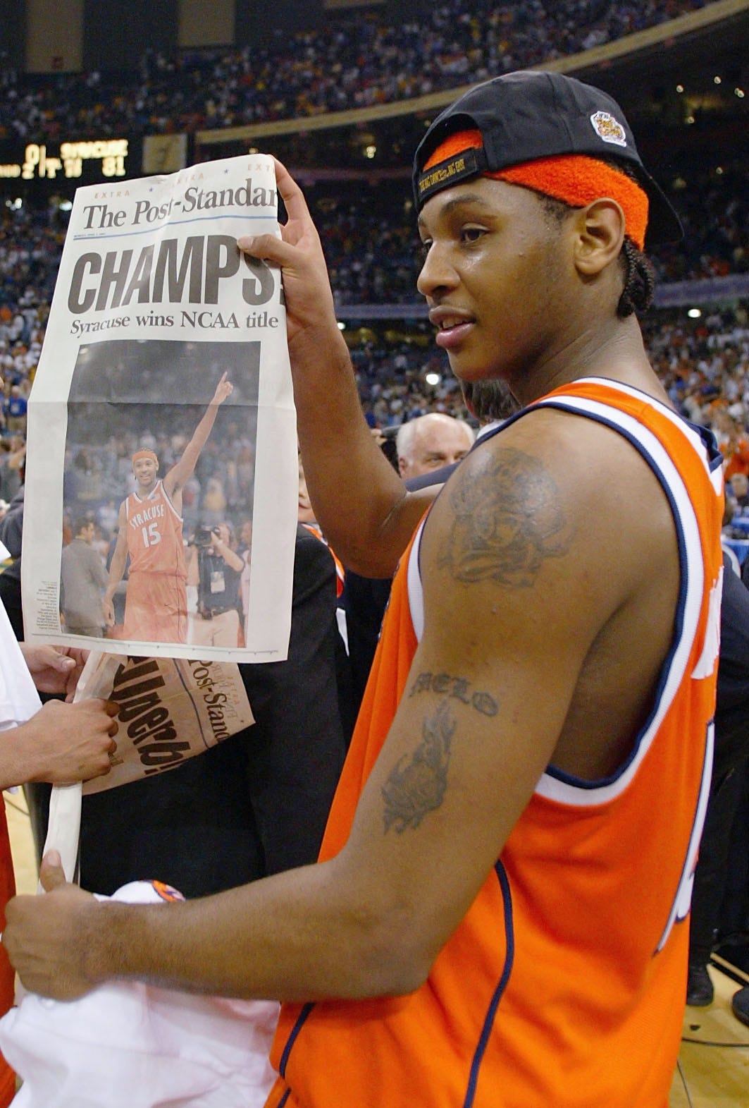 Carmelo Anthony #15 of Syracuse holds up tommorows paper, which declares the Orangeman national champs after he and his team defeated Kansas 81-78.