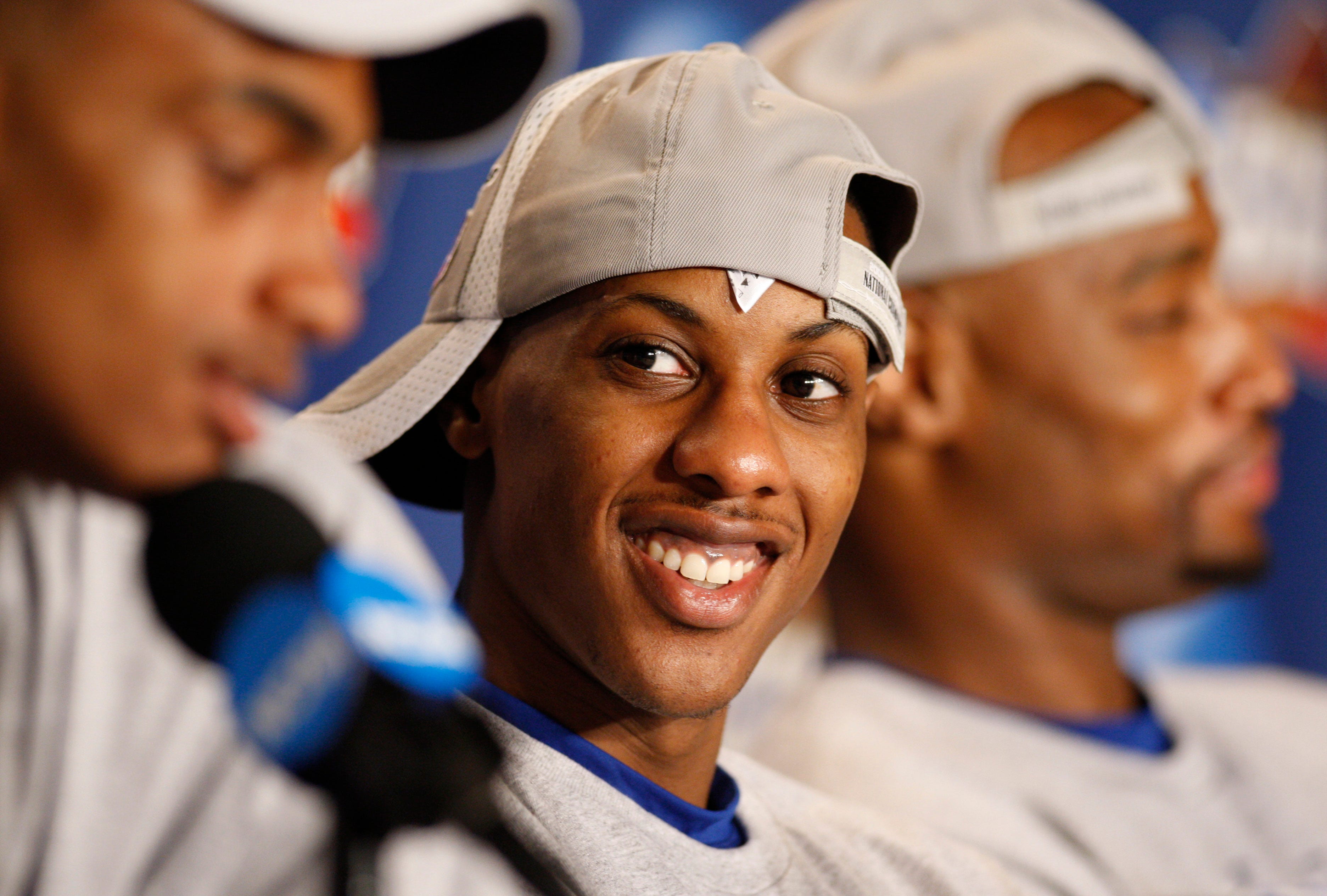 Kansas Jayhawks guard Mario Chalmers smiles as he listens to teammates.