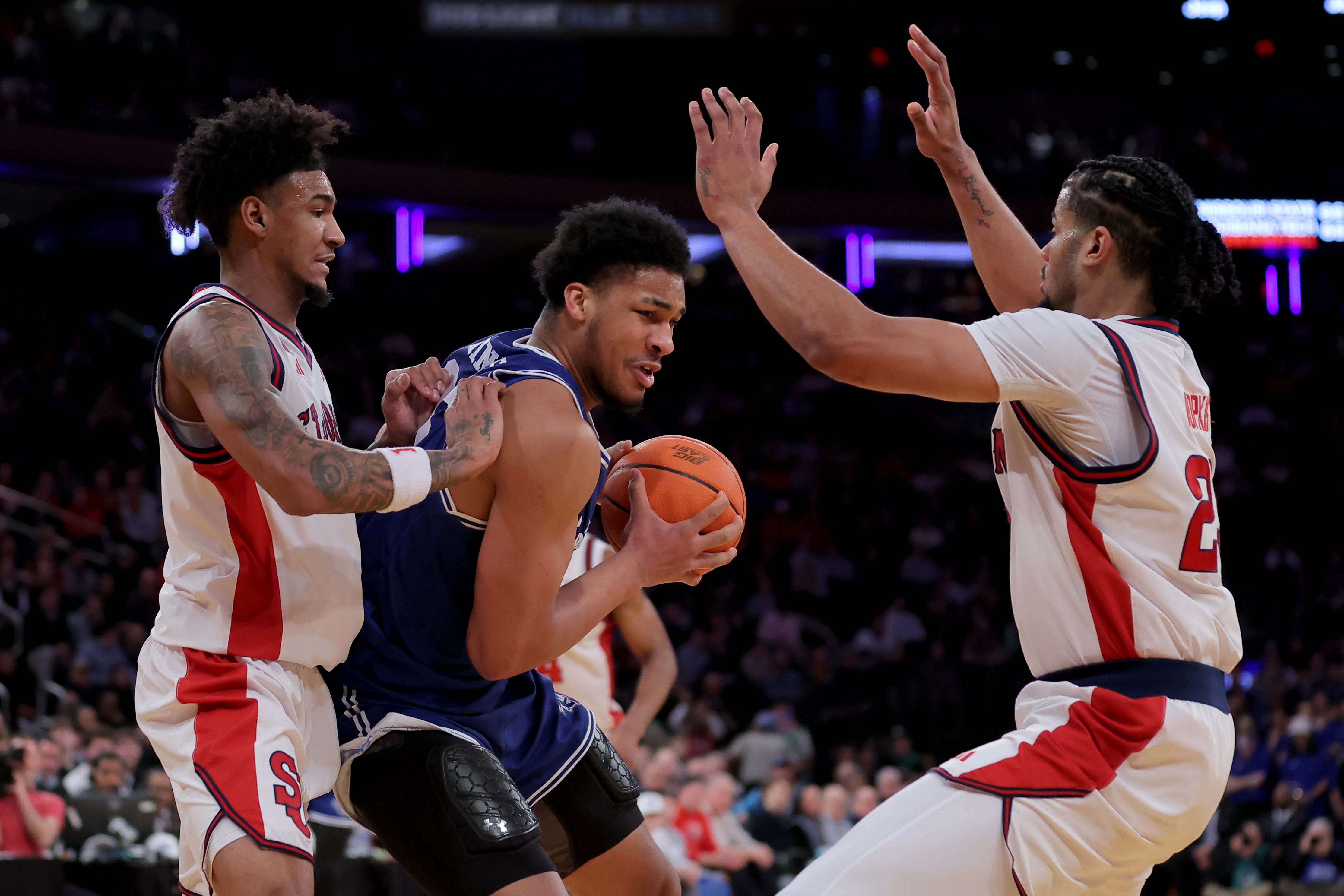 Mar 13, 2026; New York, NY, USA; Seton Hall Pirates forward Najai Hines (25) controls the ball against St. John's Red Storm forwards Dillon Mitchell (1) and Bryce Hopkins (23) during the first half at Madison Square Garden. Mandatory Credit: Brad Penner-Imagn Images