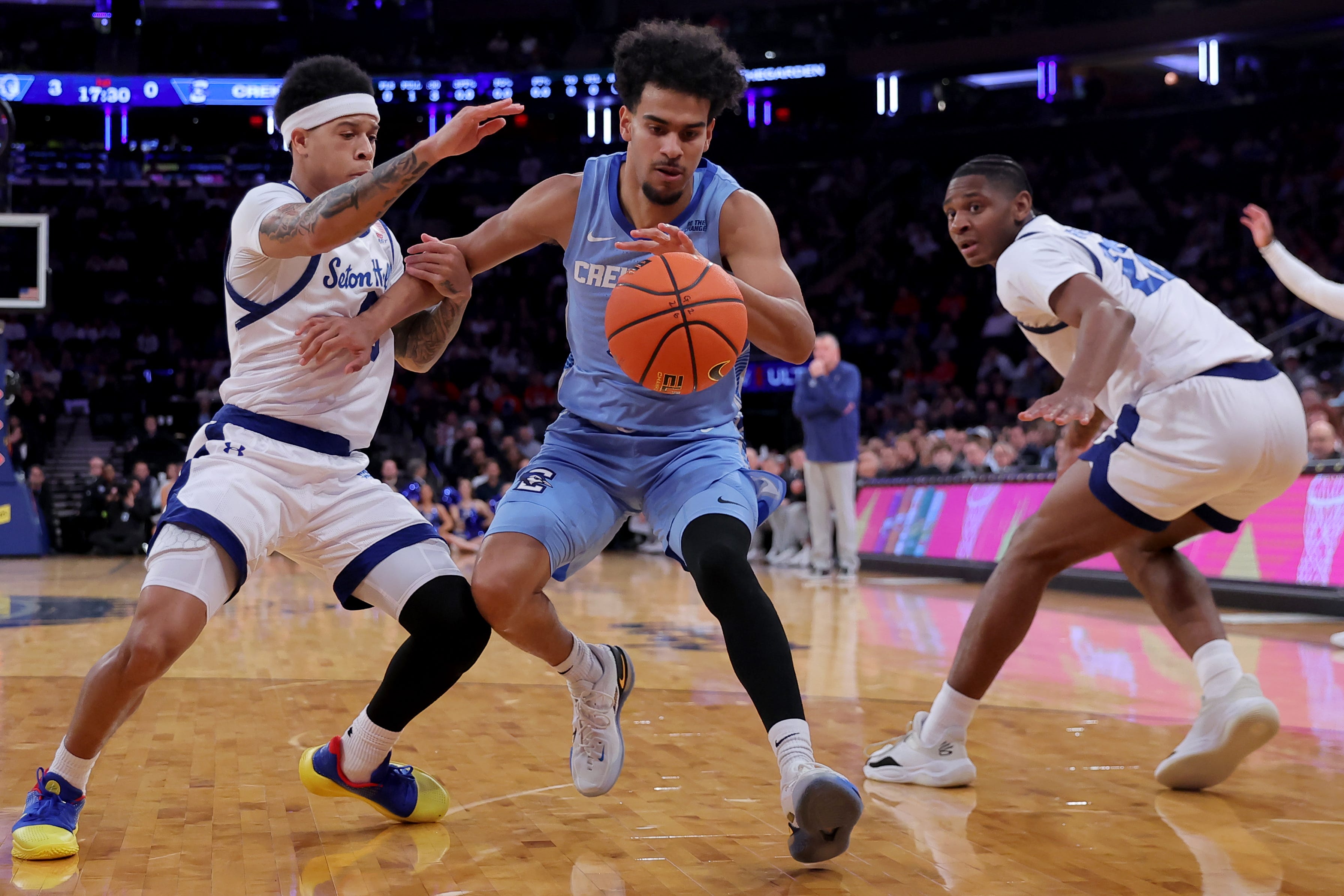 Mar 12, 2026; New York, NY, USA; Creighton Bluejays guard Nik Graves (5) controls the ball against Seton Hall Pirates guards Adam Clark (0) and Elijah Fisher (22) during the first half at Madison Square Garden.
