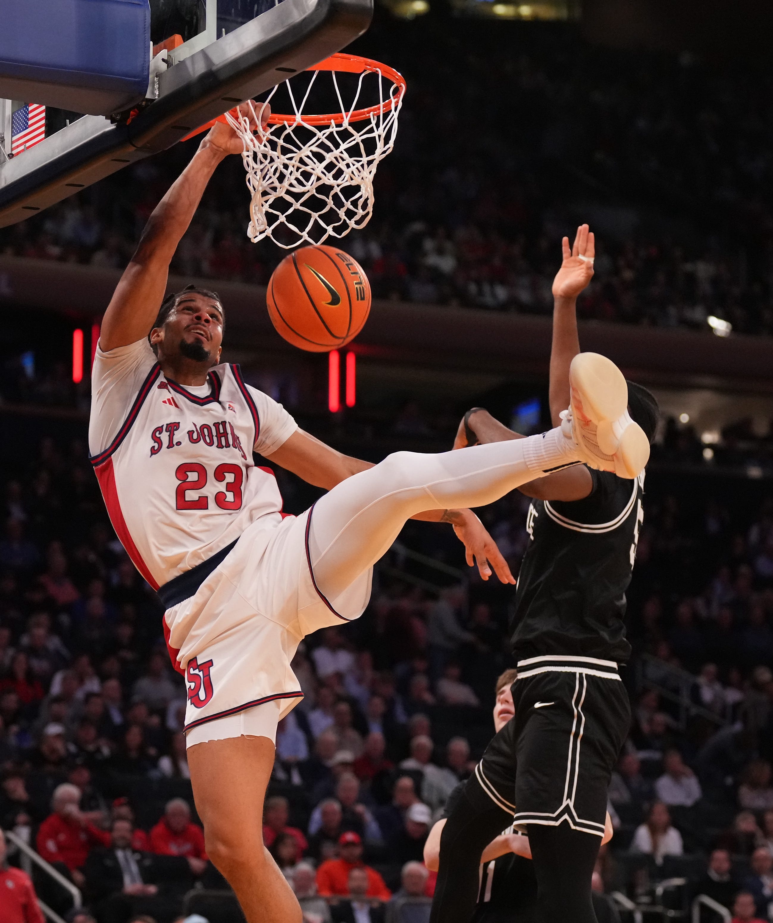 St. John's forward Bryce Hopkins dunks over Providence forward Oswin Erhunmwunse during the first half at Madison Square Garden on Thursday.