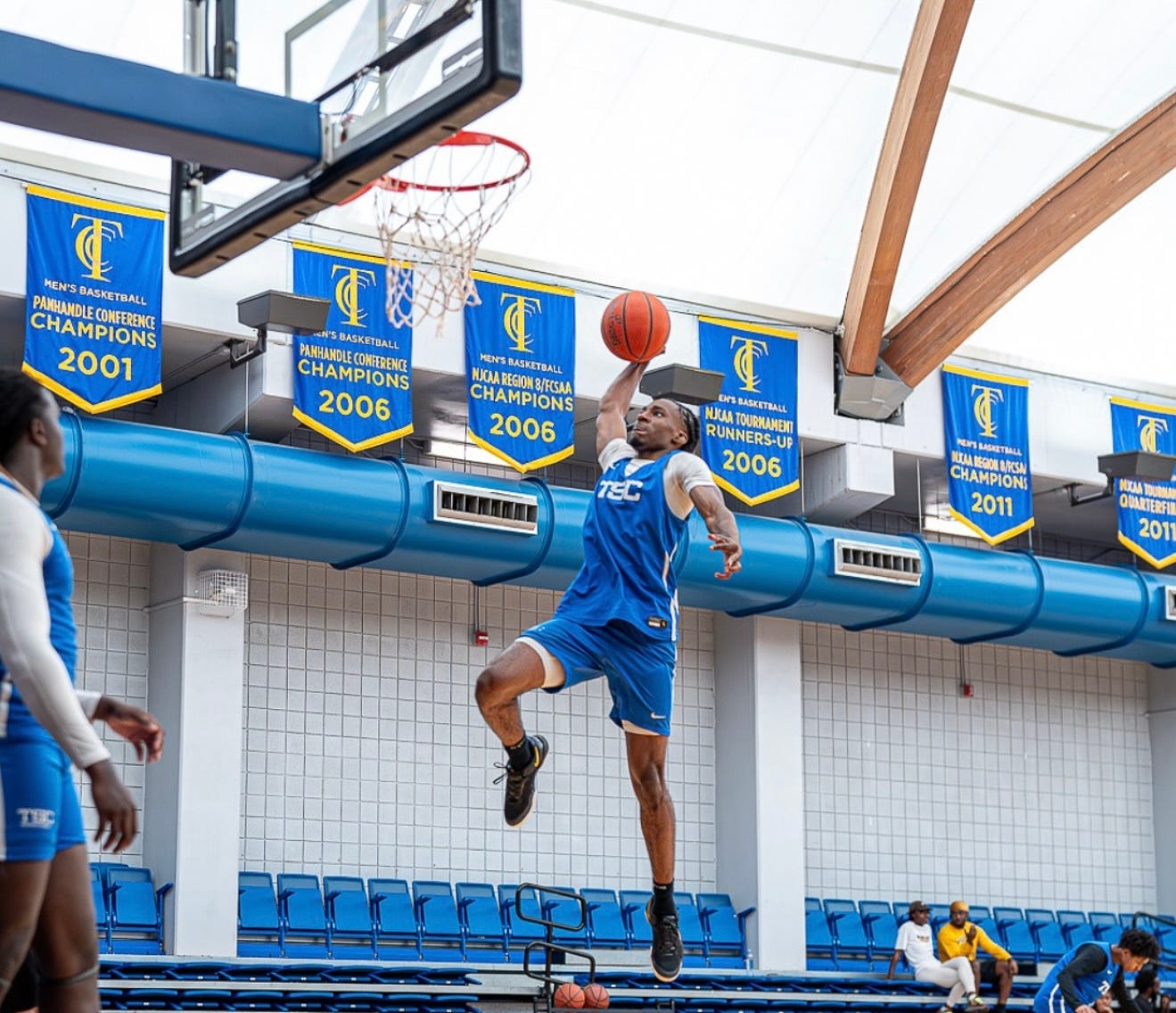 Tallahassee State College Eagles guard Amare Robinson (0) soars through the air during a college basketball practice at the Bill Hebrock Eagledome in Tallahassee, Florida.