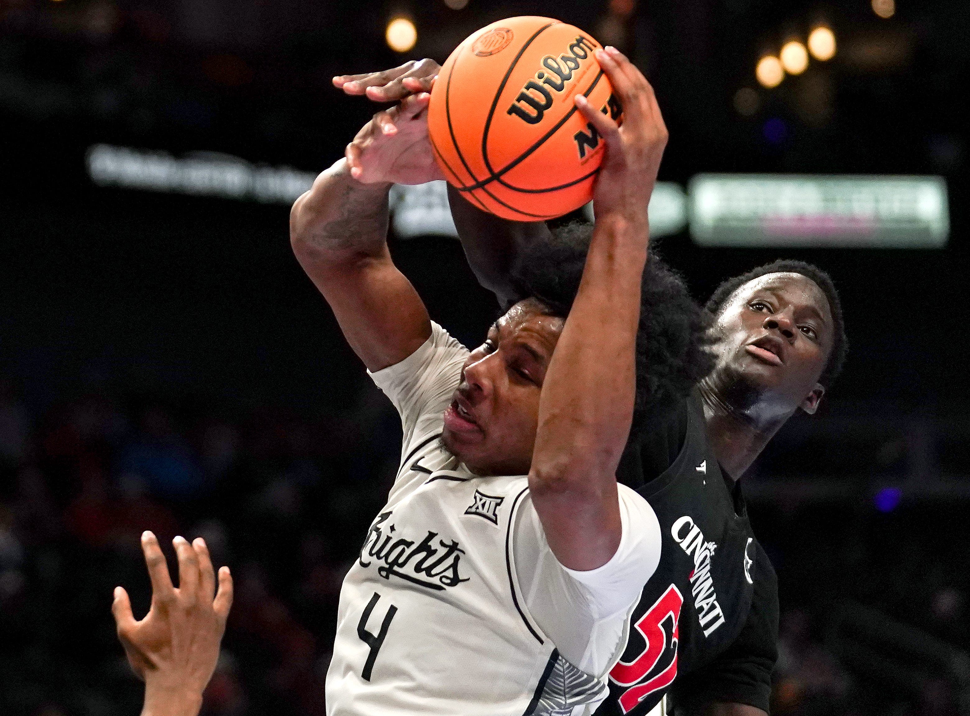 UCF Knights forward Jamichael Stillwell (4) rebounds the ball in the first half of the second round of the Phillips 66 Big 12 Men’s Basketball Tournament between the Cincinnati Bearcats and UCF Knights, Wednesday, March 11, 2026, at T-Mobile Center in Kansas City, MO.