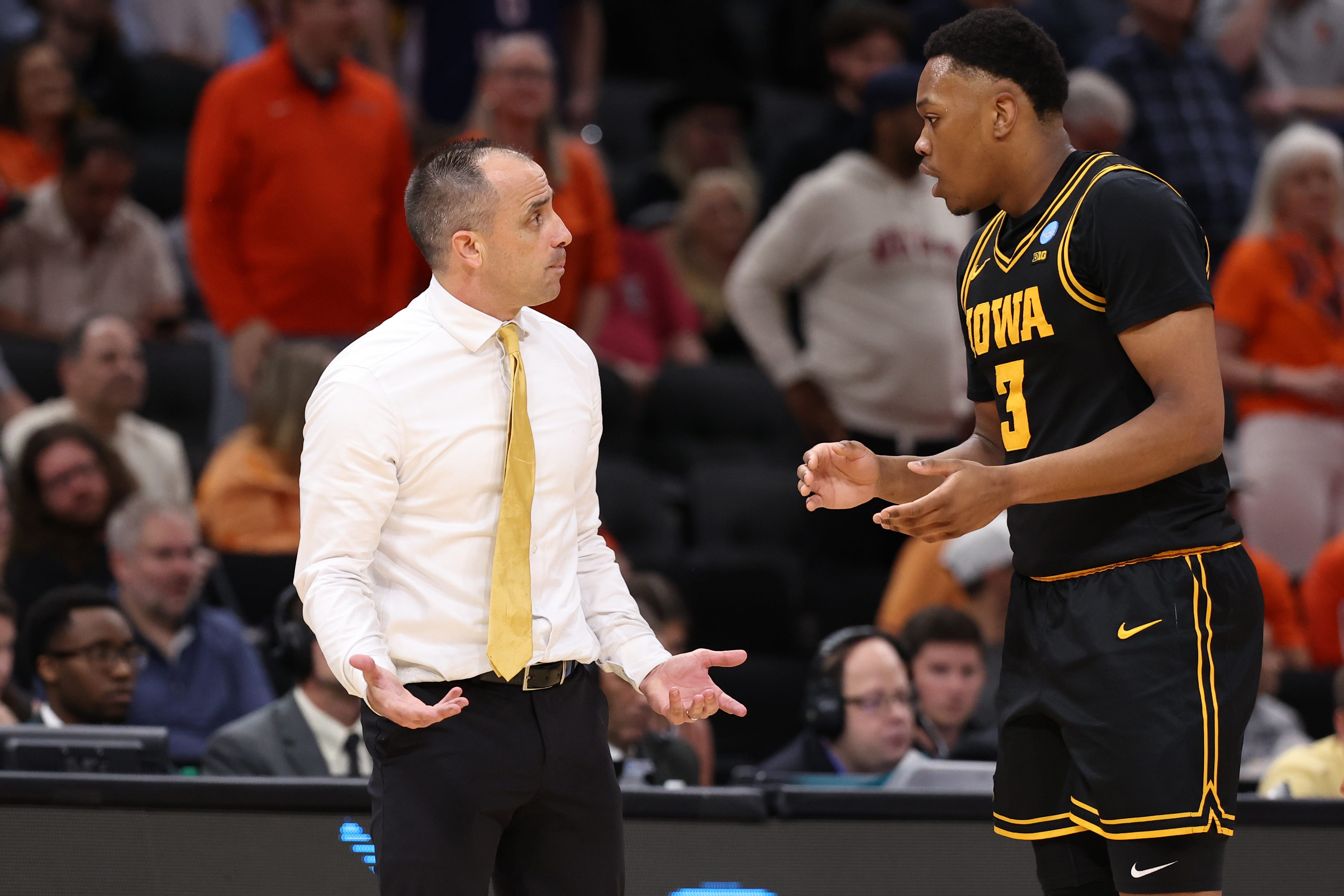 Mar 28, 2026; Houston, TX, USA; Iowa Hawkeyes head coach Ben McCollum talks with forward Cam Manyawu (3) in the second half against the Illinois Fighting Illini during an Elite Eight game of the South Regional of the men's 2026 NCAA Tournament at Toyota Center. Mandatory Credit: Troy Taormina-Imagn Images