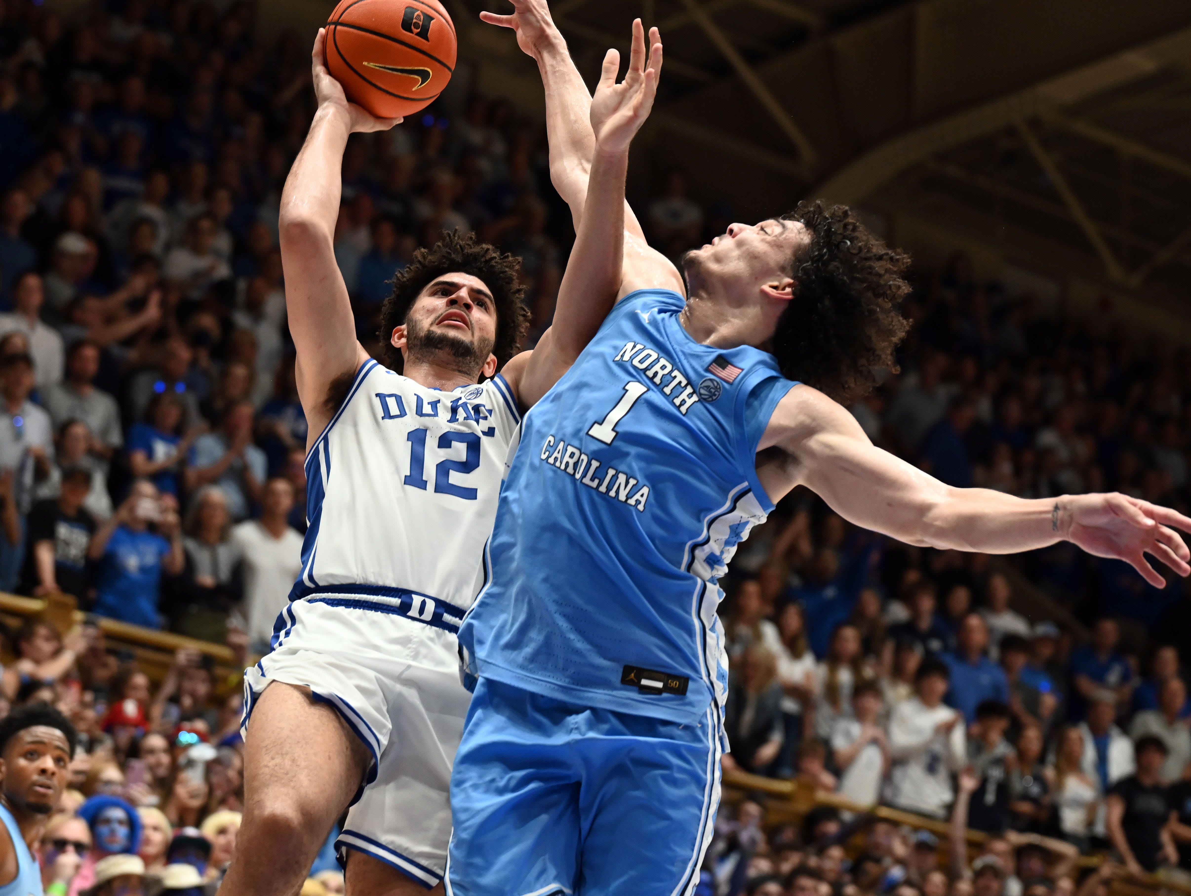 Mar 7, 2026; Durham, North Carolina, USA; Duke Blue Devils forward Cameron Boozer (12) shoots over North Carolina Tar Heels forward Zayden High (1) during the second half at Cameron Indoor Stadium. The Duke Blue Devils won 76-61. Mandatory Credit: Rob Kinnan-Imagn Images