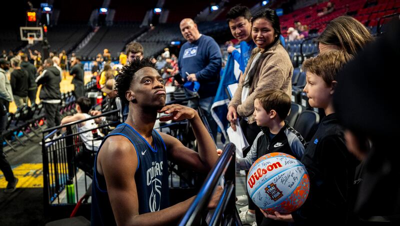 BYU forward AJ Dybantsa recalls his favorite bible verse after being posed the question by Cy Pittman, 8, right, and Hank Pittman, 6, both of Coeur d'Alene, Idaho, after a practice the day before a first-round college basketball game against Texas in the NCAA Tournament held at the Moda Center in Portland, Oregon, on Wednesday, March 18, 2026.