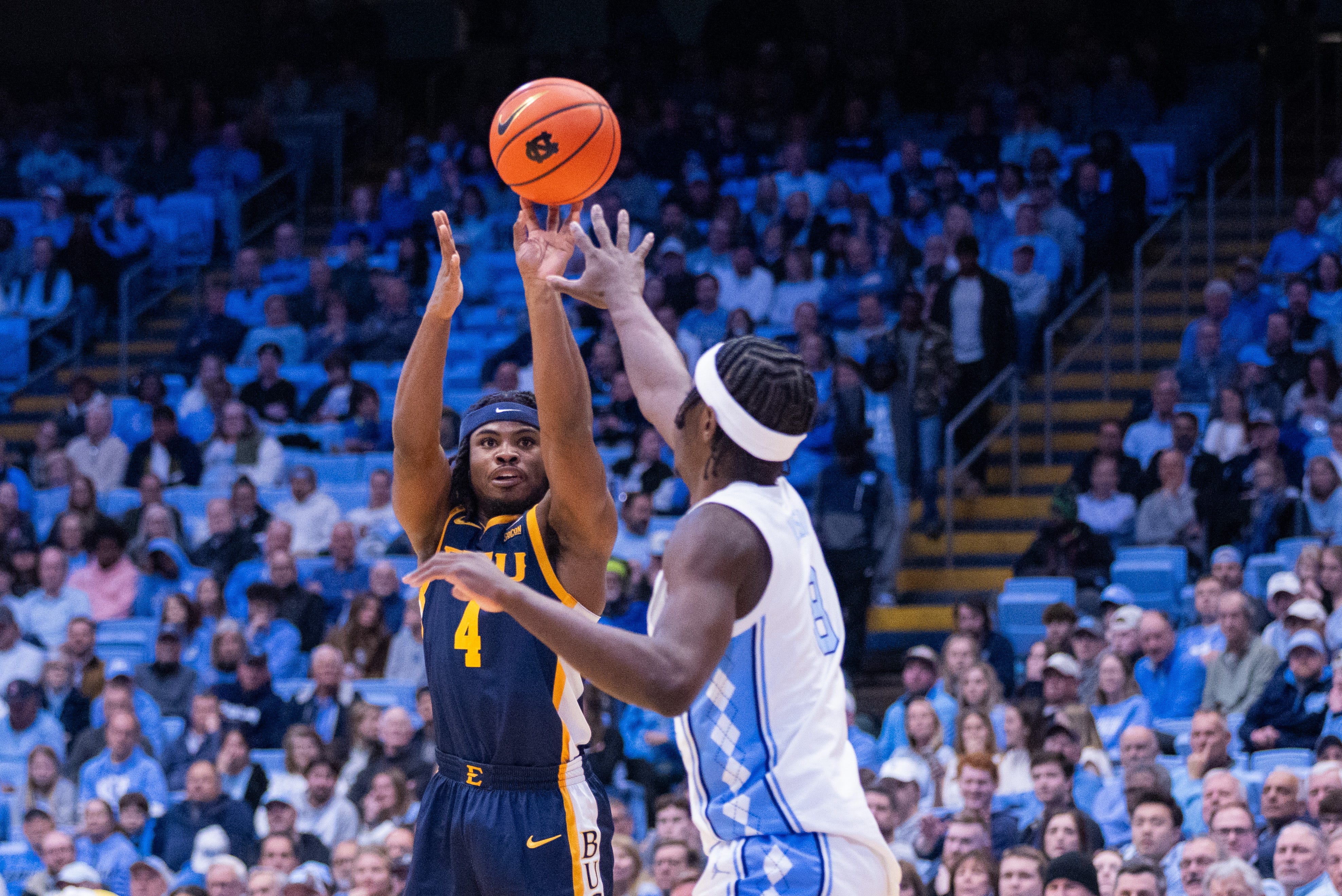Dec 16, 2025; Chapel Hill, North Carolina, USA; ETSU Buccaneers guard Jaylen Smith (4) shoots over North Carolina Tar Heels forward Caleb Wilson (8) during the first half at Dean E. Smith Center. Mandatory Credit: Scott Kinser-Imagn Images