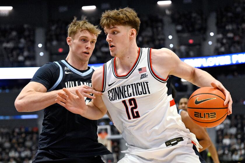UConn center Eric Reibe (12) is guarded by Villanova forward Duke Brennan.