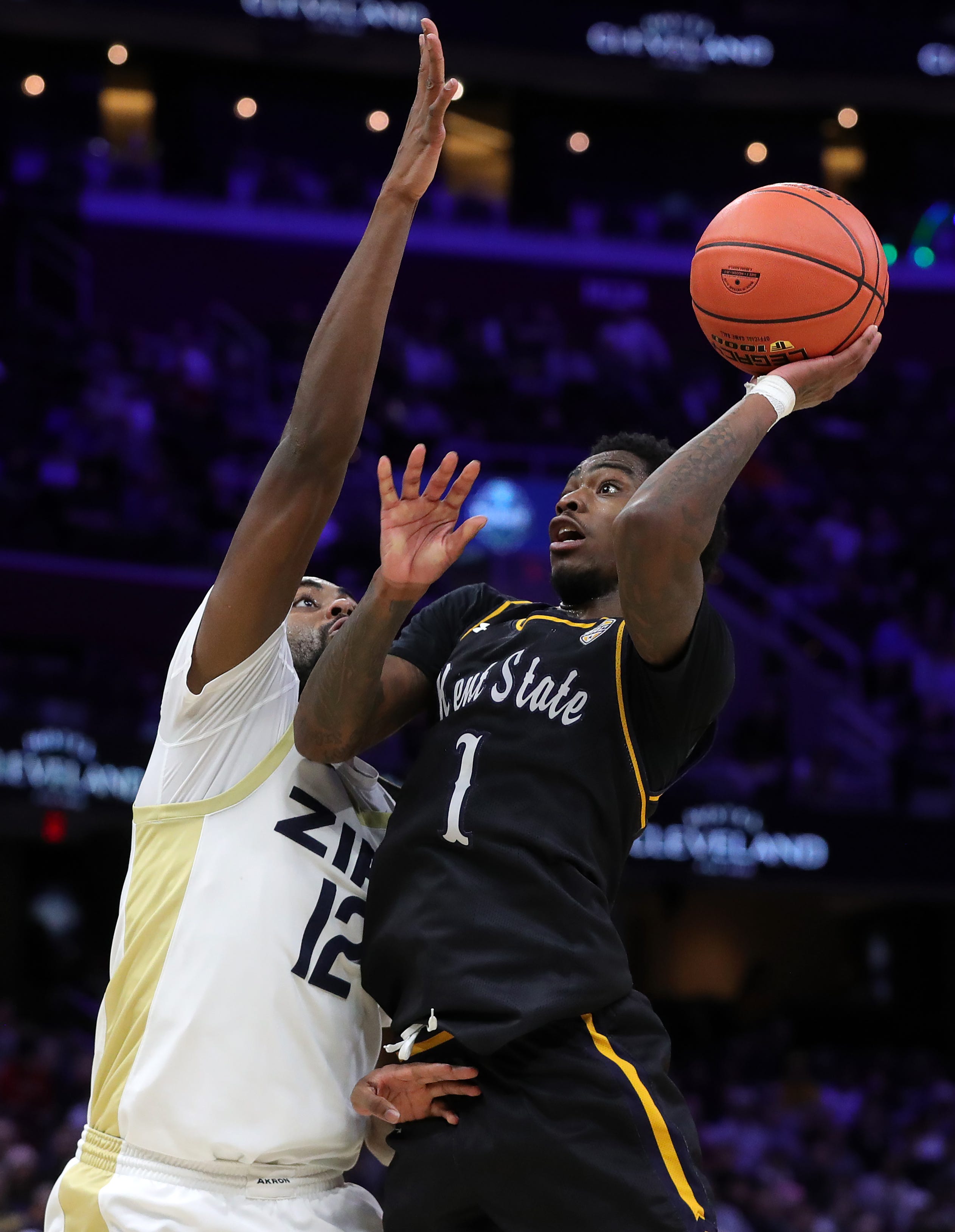 Kent State Golden Flashes guard Cian Medley (1) looks to the basket as Akron Zips wing Evan Mahaffey defends during a MAC Tournament semifinal March 13, 2026, in Cleveland.
