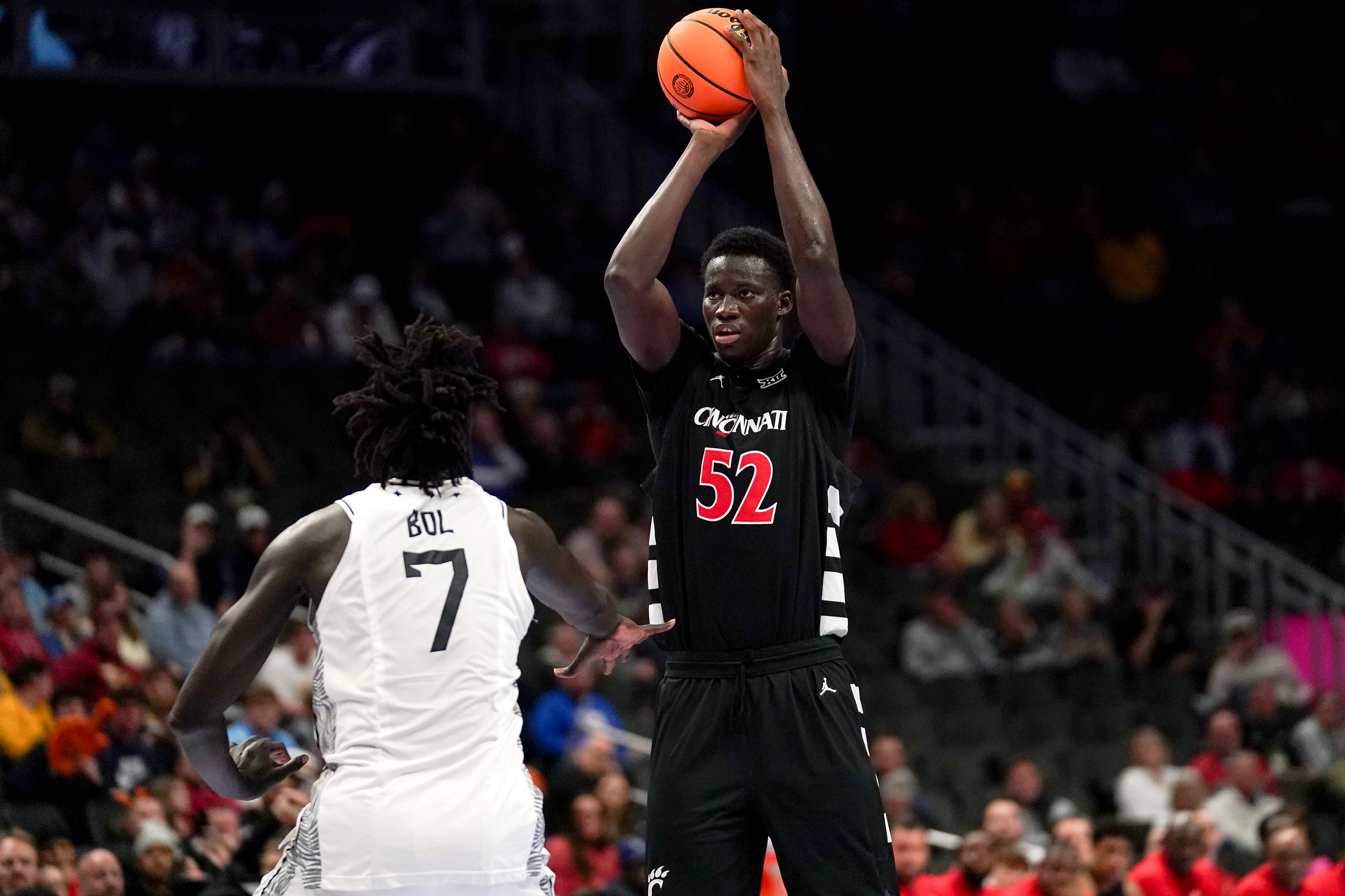 Cincinnati Bearcats center Moustapha Thiam (52) makes a basket from three point range in the first half of the second round of the Phillips 66 Big 12 Men’s Basketball Tournament between the Cincinnati Bearcats and UCF Knights, Wednesday, March 11, 2026, at T-Mobile Center in Kansas City, MO.