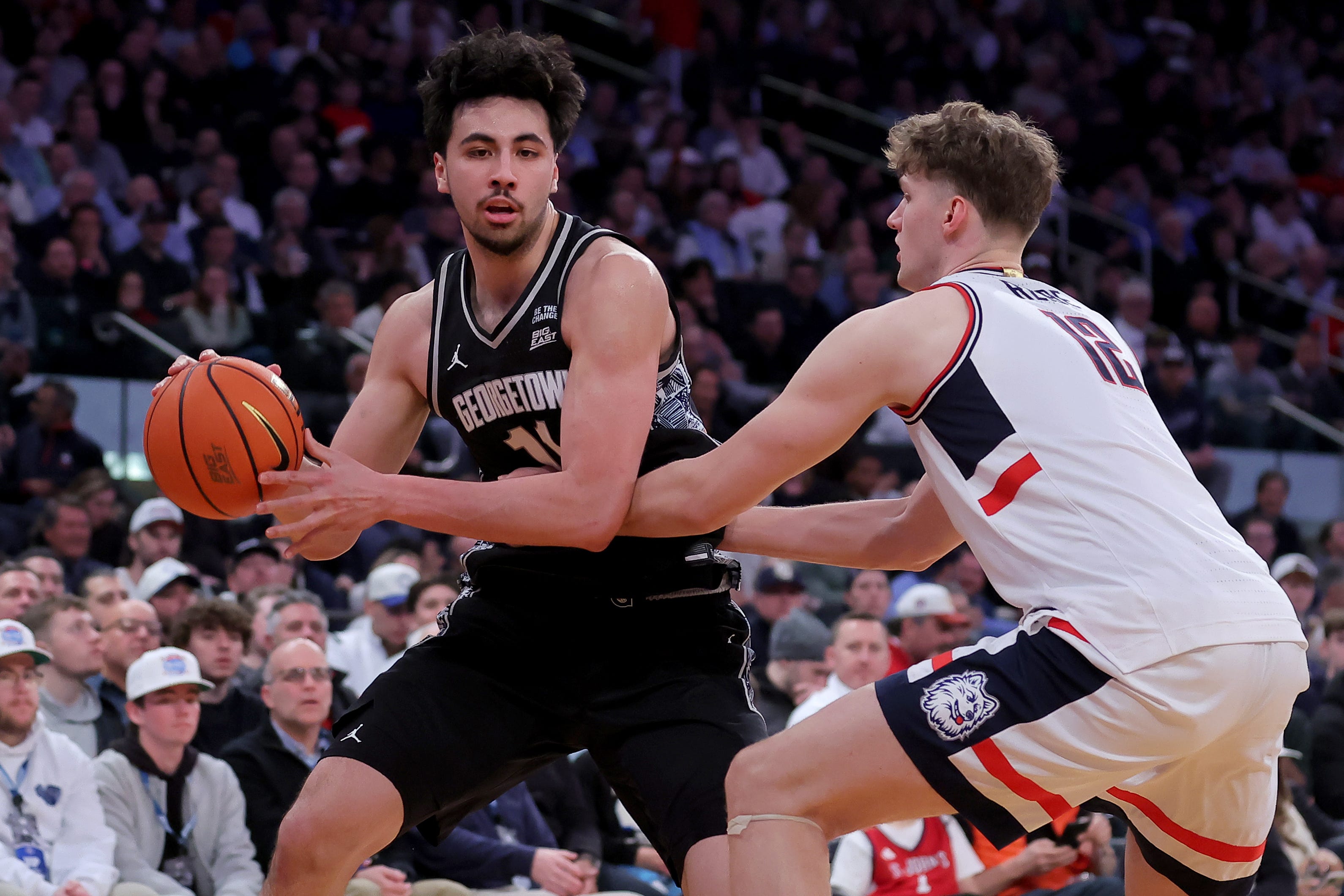 Mar 13, 2026; New York, NY, USA; Georgetown Hoyas center Julius Halaifonua (11) controls the ball against Connecticut Huskies center Eric Reibe (12) during the first half at Madison Square Garden. Mandatory Credit: Brad Penner-Imagn Images