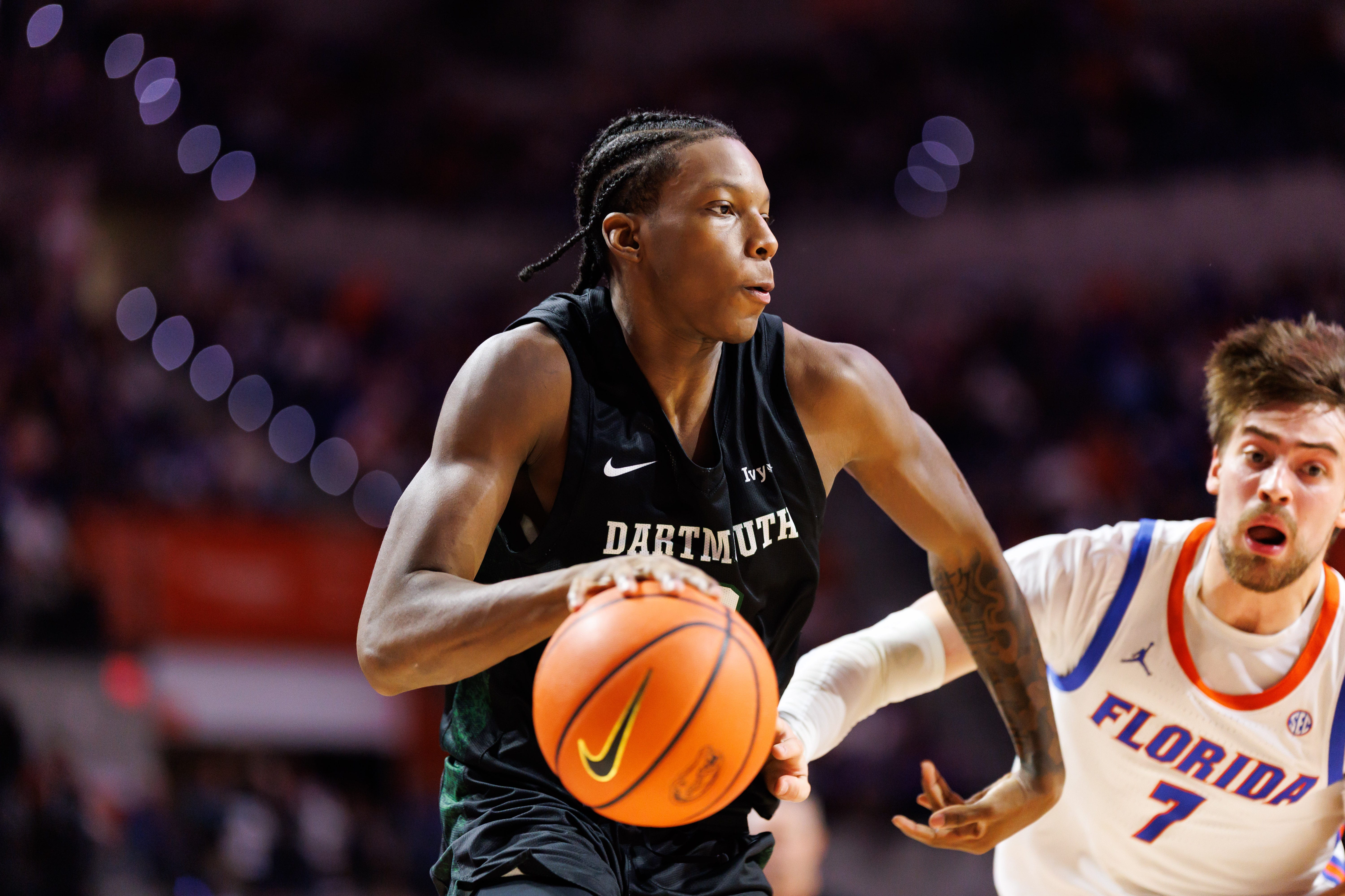 Dec 29, 2025; Gainesville, Florida, USA; Dartmouth Big Green guard Kareem Thomas (2) drives to the basket past Florida Gators guard Urban Klavzar (7) during the first half at Exactech Arena at the Stephen C. O'Connell Center. Mandatory Credit: Matt Pendleton-Imagn Images