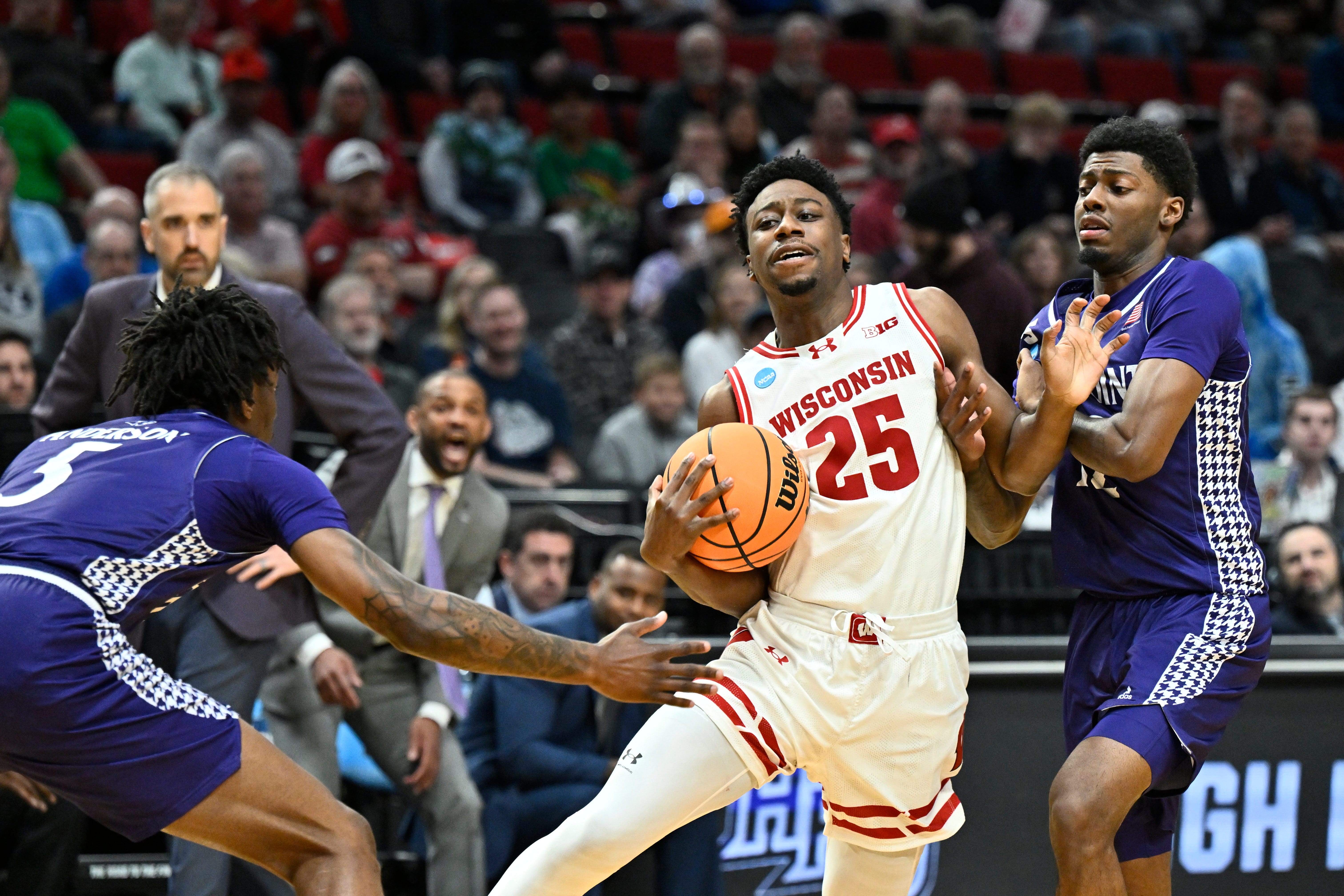 Mar 19, 2026; Portland, OR, USA; Wisconsin Badgers guard John Blackwell (25) controls the ball against High Point Panthers forward Terry Anderson (5) during the first half of a first round game of the men's 2026 NCAA Tournament at Moda Center. Mandatory Credit: Craig Strobeck-Imagn Images