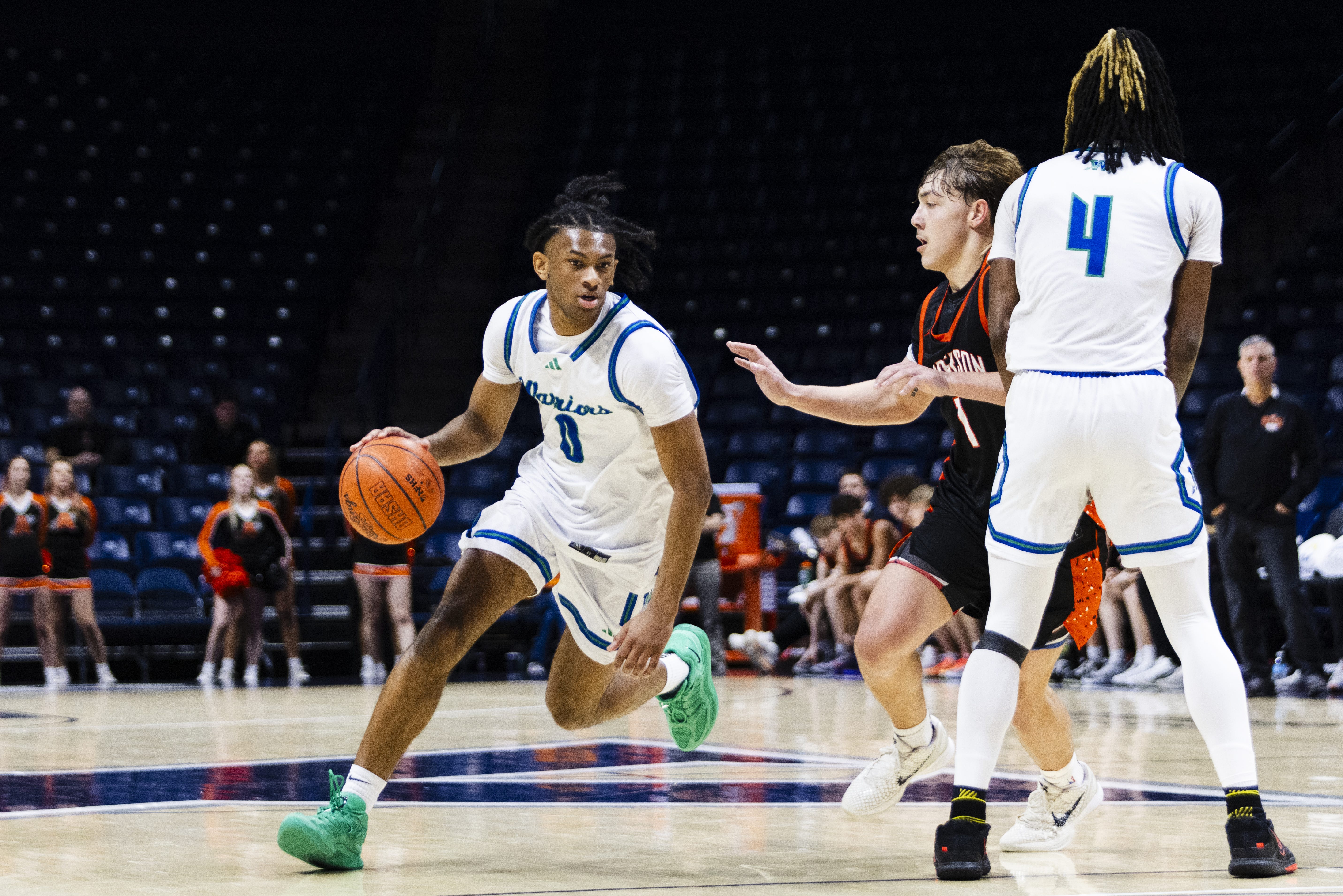 Isaiah Mack-Russell (0) of the Winton Woods Warriors dribbles toward the basket in the OHSAA DII District Finals vs. Anderson on March 6 at Xavier's Cintas Center.