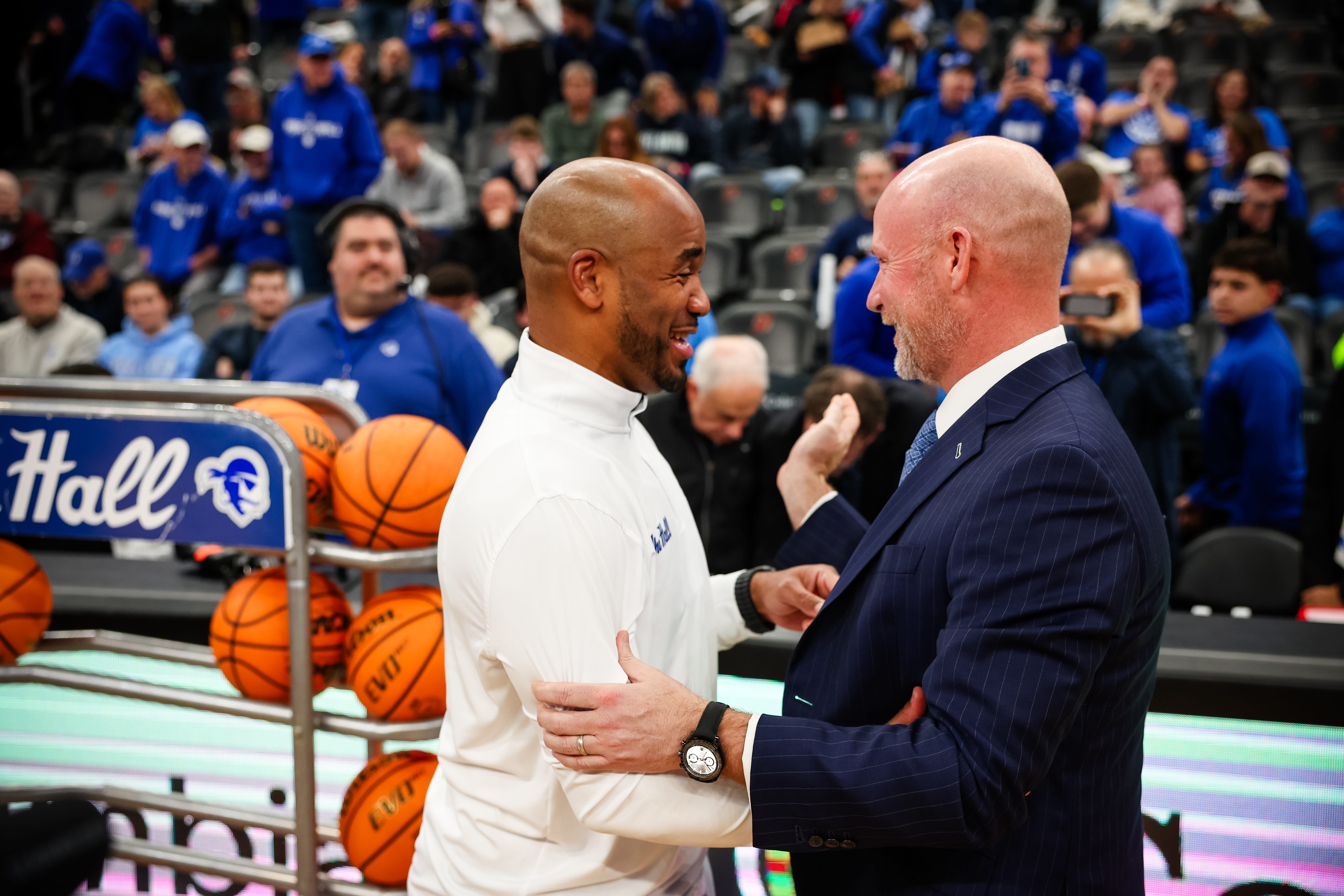 Seton Hall basketball coach Shaheen Holloway embraces Villanova coach and former Hall head coach Kevin Willard before their teams' meeting on Dec. 23, 2025.
