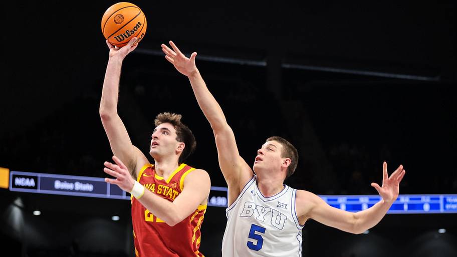 Iowa State Cyclones forward Milan Momcilovic (22) shoots the ball around Brigham Young Cougars forward Mihailo Boskovic.