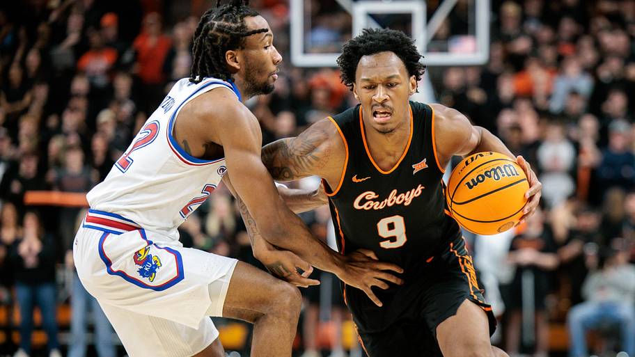 Oklahoma State Cowboys guard Anthony Roy (9) drives around Kansas Jayhawks guard Darryn Peterson.