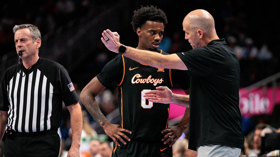 Oklahoma State Cowboys coach Steve Lutz speaks with Oklahoma State Cowboys guard Jaylen Curry during a game