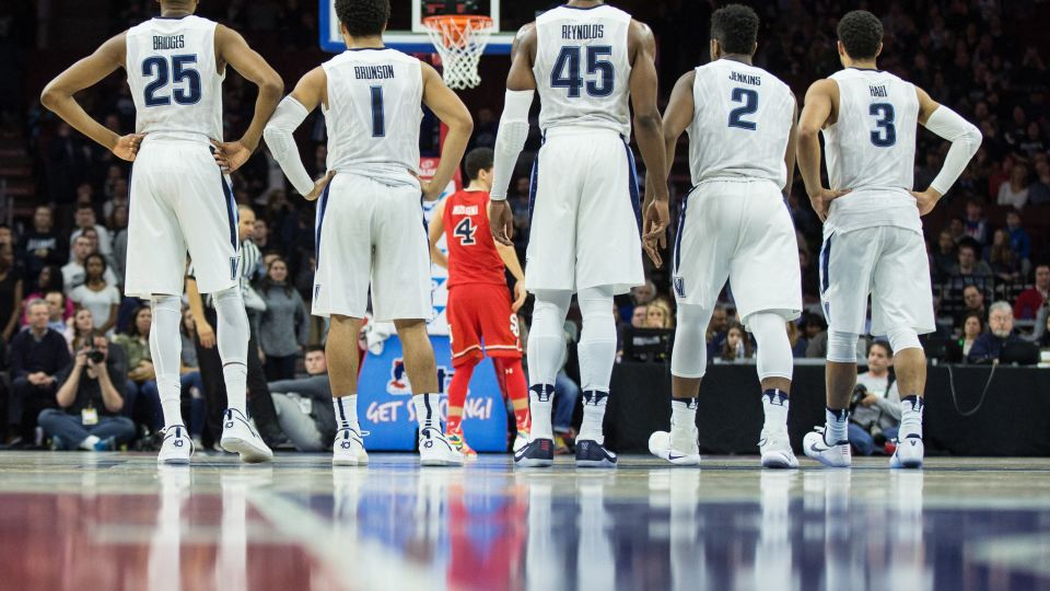 Villanova Wildcats guard Mikal Bridges (25) and guard Jalen Brunson (1) and forward Darryl Reynolds (45) watch on as St. John's Red Storm guard Federico Mussini (4) shoots a technical during the second half at Wells Fargo, in Philadelphia, on February 4, 2017. - Bill Streicher/USA Today/Imagn/Reuters