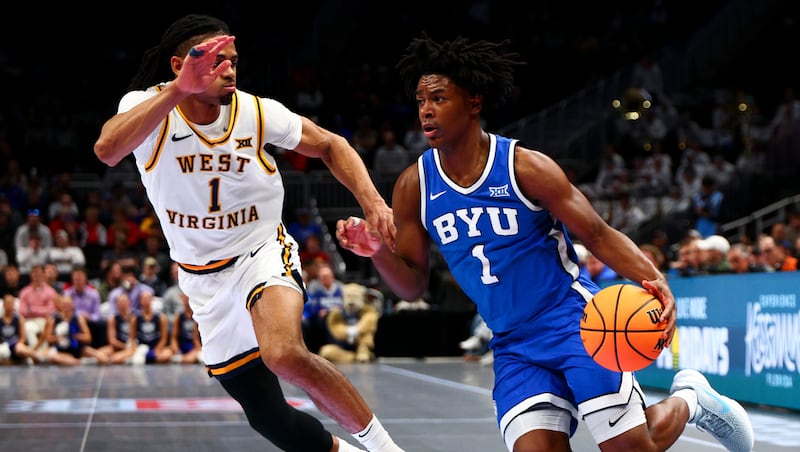 BYU guard Robert Wright III (1) drives past West Virginia Mountaineers guard Jasper Floyd (1) during second round of the 2026 Phillips 66 Big 12 Men's Basketball Tournament at the T-Mobile Center in Kansas City, Missouri, on Wednesday, March 11, 2026.